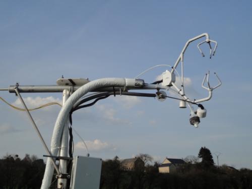 Eddy covariance mast with a sonic anemometer and gas sampling lines.