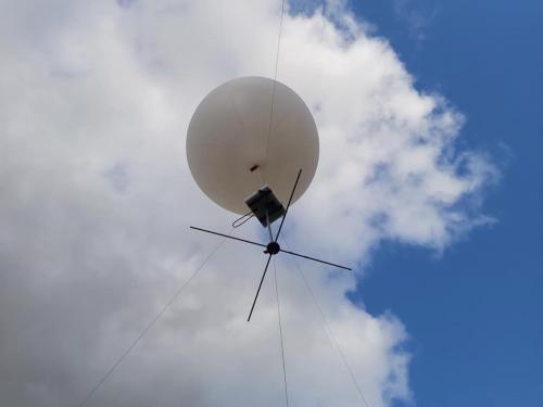 Dipole antennas located below helium-filled weather balloon
